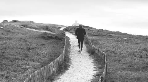 A jogger in sequential views appears in multiple static poses - b&amp;w - zoom out Stock Footage 49388652