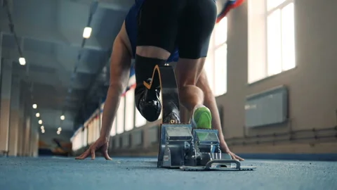 Jogger starts to sprint, wearing bionic leg, back view. Stock Footage 100833742