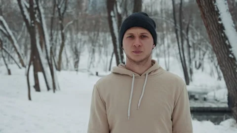 Jogger walking tired after training in winter park Stock Footage 147942641