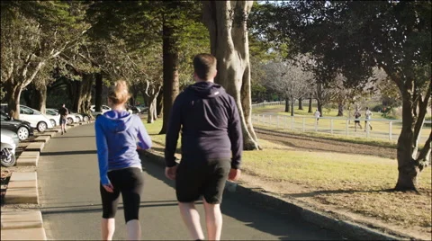 Joggers and Walkers in park Stock Footage