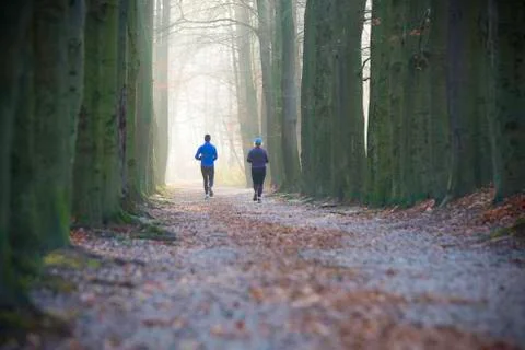Joggers in a park Stock Photos