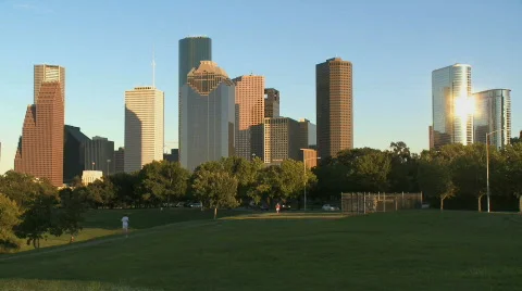 Joggers run beneath the Houston skyline Stock Footage