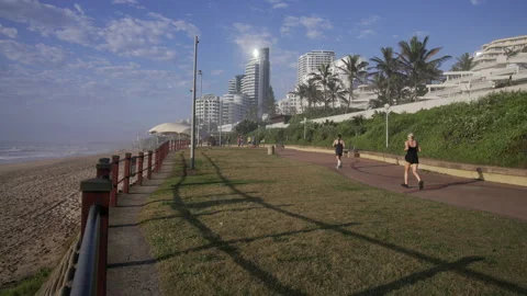 Joggers running on seafront promenade. Stock Footage 171445108