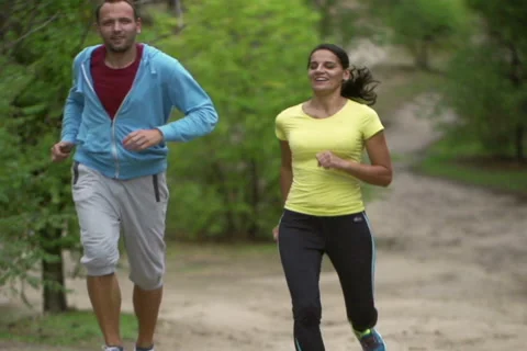Joggers smiling to the camera, slow motion shot at 240fps, steadycam shot Stock-Footage 43739486