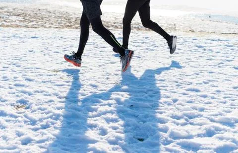 Joggers in snow Stock Photos