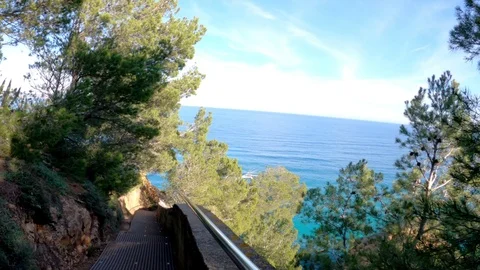 Jogging along the coastal cliffs. View from the runner perspective. Picturesque Stock Footage 123122254