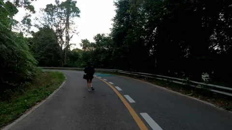 Jogging along the evening route passing around a large reservoir. Stock Footage 230078504
