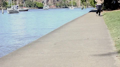 Jogging Along Riverbank Stock Footage 8516562