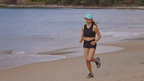 Jogging and exercising on a beautiful tropical beach Видео 152384521
