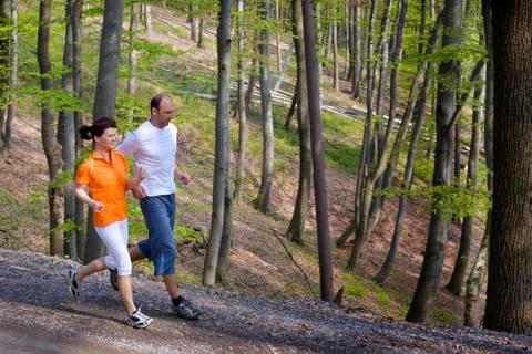 Jogging couple in forest Stock Photos