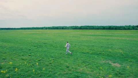 Jogging in the field. The man is training. Sport. Aerial photography. Stock Footage 310514894
