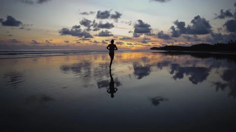 Jogging in front of a beautiful sunset Stock Footage 151703975