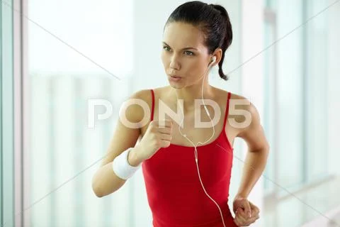 A jogging girl listening to the music Stock Photos
