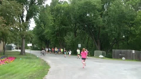 Jogging in Group Down Road Video stock 12613049