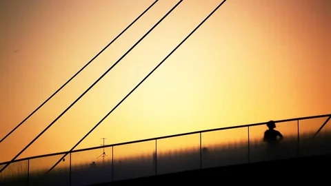 Jogging People on Bridge Sunset Backlit Silhouette Stock Footage