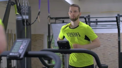 Jogging with pleasure. mirror image of young handsome man running on treadmill Stock Footage 113424060