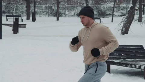 Jogging on snow in winter park Stock Footage 147941004