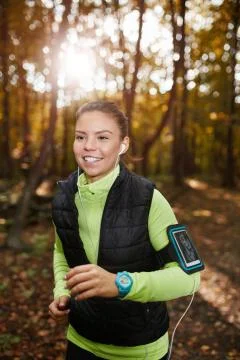 Jogging through the forest with music Stock Photos