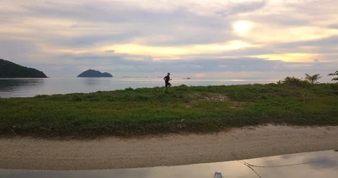 Jogging at top line on the sunset beach Stock Footage 89251472