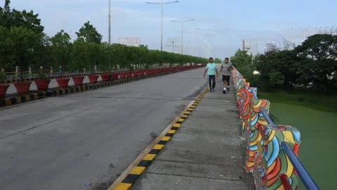 Jogging-walking-on-sidewalk Stock Footage 141169962