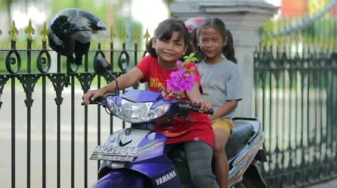 JOGJAKARTA - MAY 2012: two local kid on motorbike Stock Footage 12170276