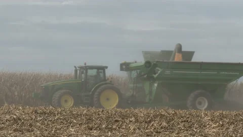 John Deere Combine - Harvesting Corn - Dusty Corn Field Stock Footage 163073945