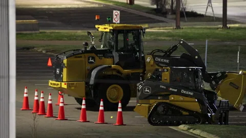 John Deere Excavator and Loader Parked in Moncton Lot at Night Stock Footage 330792403