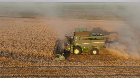 John Deere grain harvester at work. Combine harvester with straw chopper works Stock Footage 250386408