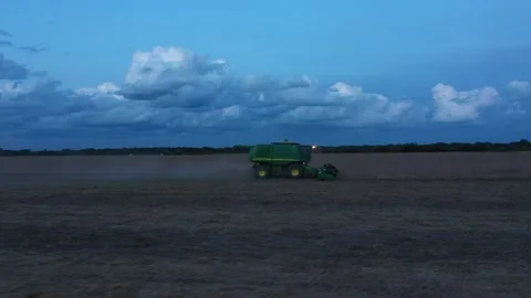 John Deere Harvester in the sunset. Stock Footage 153876806