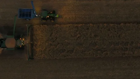 John Deere Header overhead footage filling bucket trailer Stock Footage 94118464