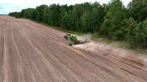 John Deere tractor with Amazone Condor on wheat seeding at field. Video stock 213548070