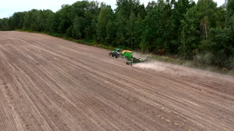 John Deere tractor with Amazone Condor on wheat seeding at field. Video stock 213550379