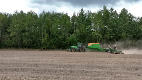 John Deere tractor with Amazone Condor on wheat seeding at field. Stock Footage 213568192