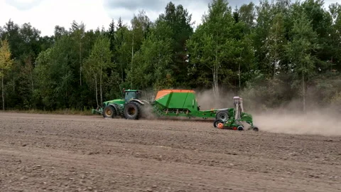 John Deere tractor with Amazone Condor on wheat seeding at field. 動画素材 213571405