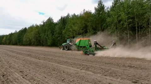 John Deere tractor with Condor trailed seed drill. wheat seeding Stock Footage 212597349