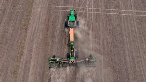 John Deere tractor with Condor trailed seed drill. wheat seeding Stock Footage 212599398