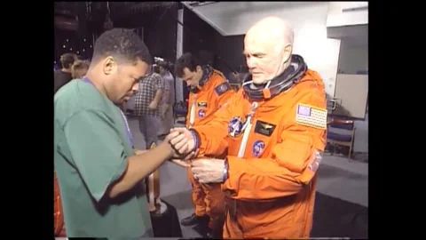 John Glenn dressing in spacesuit for flight on space shuttle Discovery Stock Footage 262065021