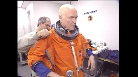 John Glenn dressing in spacesuit for flight on space shuttle Discovery Stock Footage 262065062