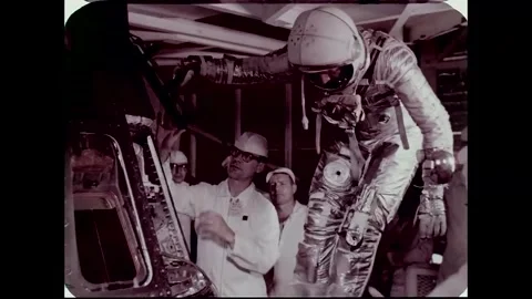 John Glenn protective shoe covers being removed prior to entering space capsule  Stock Footage 262065192