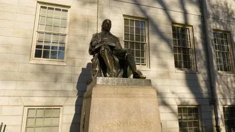 John Harvard Statue on Harvard University Campus. Tourists Rub the Toe of Stock Footage 196002815