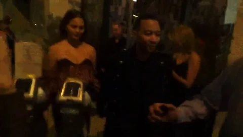 John Legend and Chrissy Teigen heading to their car Stock Footage 73781035