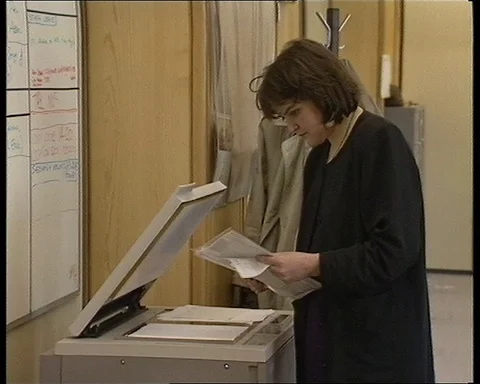 John Warden talking about press while people are working in office, UK 1990 Stock Footage 147438129