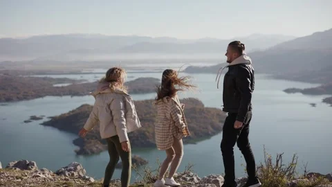 Join the excitement as friends conquer the mountain top and revel in the Stock Footage 241278020