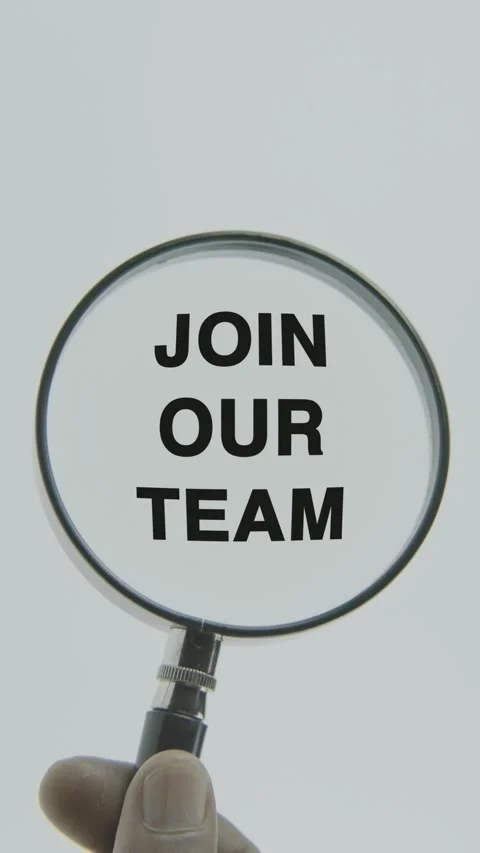 Join Our Team text or word highlighted by a magnifying glass in a hand Stock Footage 303472025