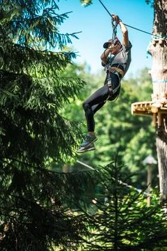 Join us for an adventurous ziplining experience, navigating through a lush .. Stock Photos