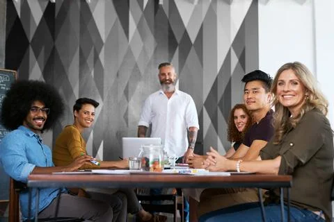 Join us. Cropped portrait of a group creative colleagues sitting in the Foto stock