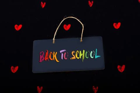 Join us label on a black notice board  and red hearts Stock Illustration