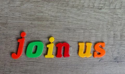 Join us   sentence written with  plastic letters on a wooden table . Looking Stock Photos