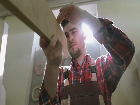 Joiner checking a sawing quality of wooden board. Stock Footage 74893211