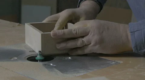 Joiner making edges on box with electric grinder in workshop, hands close up. 스톡 동영상 57748473